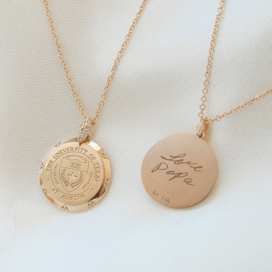 Two gold necklaces on a light background