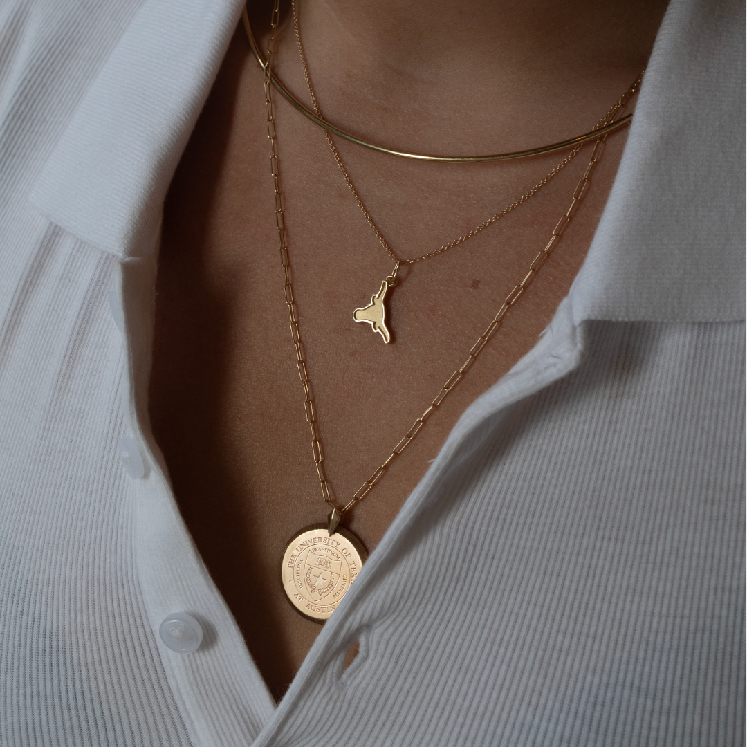 UT Longhorn Charm shown on figure in gold on Cable Chain with Neck Collar in gold and UT Florentine Pendant in size Large on long Link Chain