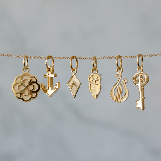 Alpha Omicron Pi Rose Charm, Delta Gamma Anchor Charm, Theta Kappa Alpha Kite Chain, Chi Omega Owl Charm, Alpha Chi Omega Lyre Charm, Kappa Kappa Gamma Key Charm shown in Cavan Gold on Cable Chain