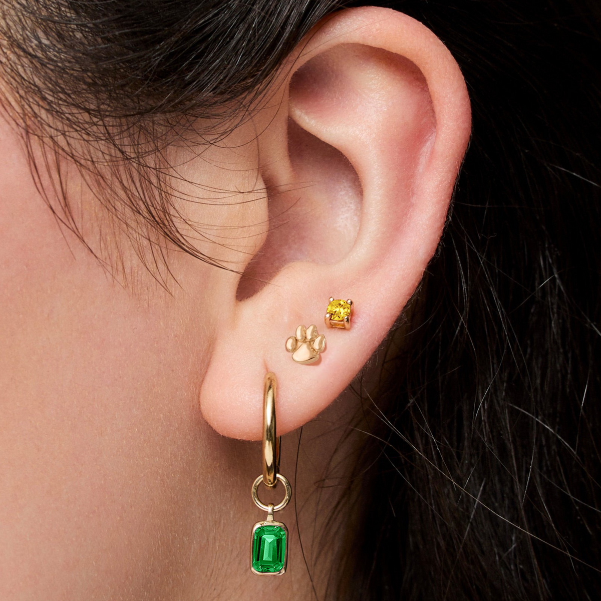 Georgetown Visitation Paw Stud shown on figure in gold with Emerald Gemstone Earring Charm and Yellow Citrine Gemstone Stud