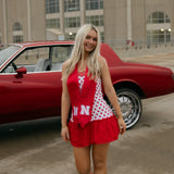 Nebraska Sunburst Bundle shown on figure in gold with Nebraska Logo Charm in gold