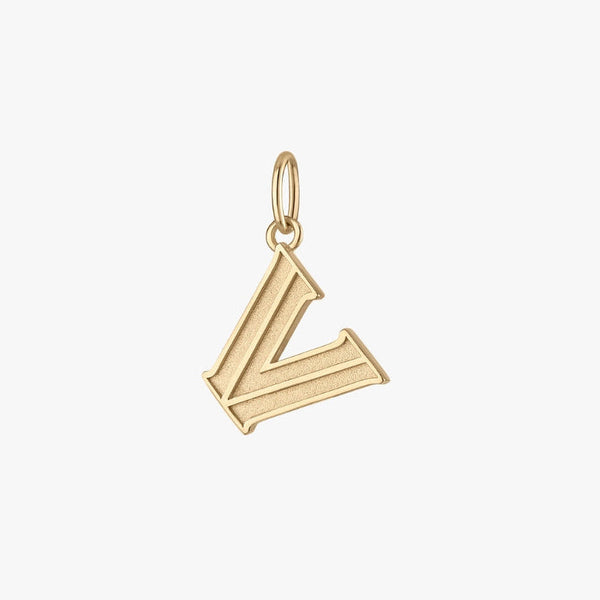 Close-up of a charm with a gold design on a white background