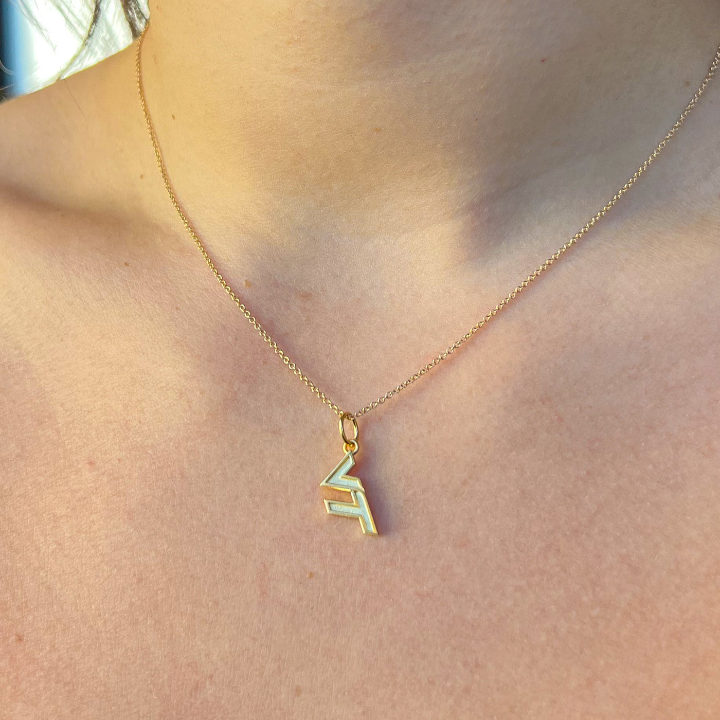 Virginia Tech VT Charm shown on figure in gold on Cable Chain