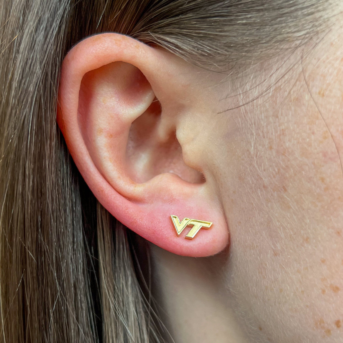 Virginia Tech VT Logo Stud shown on figure in gold