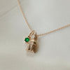 Notre Dame Golden Dome Pendant shown in gold on Cable Chain with Emerald Gemstone laydown