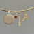 Alabama Sunburst Pendant, Garnet Gemstone Charm, Alabama Denny Chimes Pendant, and Alabama Logo Charm shown on Neck Collar in Gold