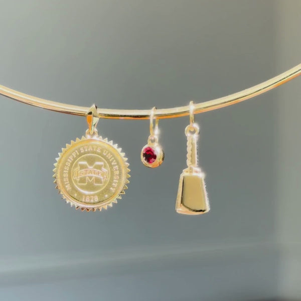 Mississippi State Crest Sunburst Pendant shown on Neck Collar with Garnet Gemstone Charm and Cowbell Charm in gold