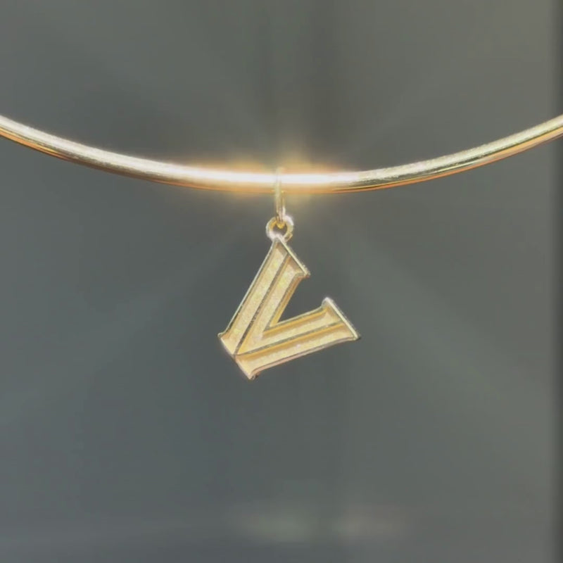 Villanova Logo Charm shown on Neck Collar in gold