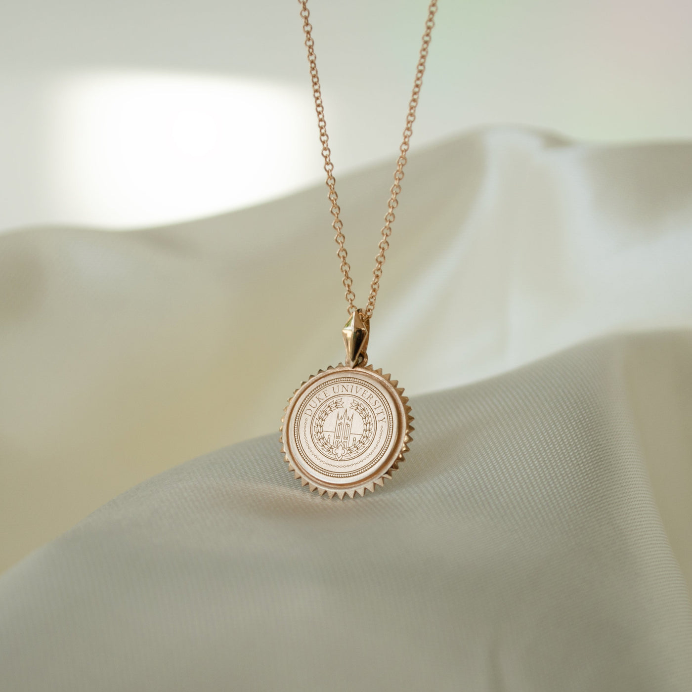 Duke University Sunburst Pendant shown on Cable Chain in gold