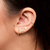 Sunburst hoop earrings on figure 